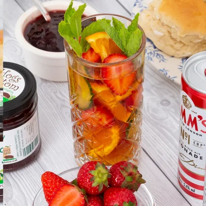 Glass filled with Pimms, lemonade and fresh fruit